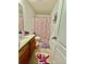 Bathroom with wooden vanity, patterned shower curtain, and decorative rugs adding charm at 3032 Cedar Glade Ln, Buford, GA 30519