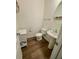 Stylish powder room with modern pedestal sink and hardwood floors at 3032 Cedar Glade Ln, Buford, GA 30519