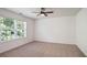 Bright bedroom with large window providing natural light and a ceiling fan at 3032 Cedar Glade Ln, Buford, GA 30519