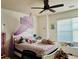 Bright and charming bedroom features ceiling fan, large window and a playful bed with whimsical decor at 3032 Cedar Glade Ln, Buford, GA 30519