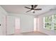 A naturally lit bedroom featuring two doors and a window with a wooded view at 3032 Cedar Glade Ln, Buford, GA 30519