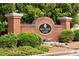 Brick community sign for Mill Creek Lakes with lush green landscaping and decorative rock features at 3032 Cedar Glade Ln, Buford, GA 30519