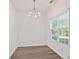 Bright dining room featuring hardwood floors, white walls, and a chandelier above at 3032 Cedar Glade Ln, Buford, GA 30519