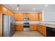 Well-lit kitchen with stainless steel appliances, hardwood cabinets and plenty of counter space at 3032 Cedar Glade Ln, Buford, GA 30519