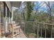 Relaxing balcony with wood chairs overlooking a serene, wooded view at 3071 Lenox Ne Rd # 11, Atlanta, GA 30324