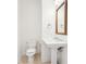 Clean powder room with pedestal sink, framed mirror, and neutral color scheme at 3071 Lenox Ne Rd # 11, Atlanta, GA 30324