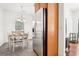 Cozy dining area with white chairs, decorative chandelier, and stainless steel refrigerator at 3071 Lenox Ne Rd # 11, Atlanta, GA 30324