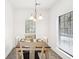 Bright dining area featuring a wooden table, four chairs, and a decorative chandelier at 3071 Lenox Ne Rd # 11, Atlanta, GA 30324