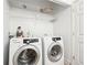 Laundry room equipped with a modern washer and dryer set and shelving at 3071 Lenox Ne Rd # 11, Atlanta, GA 30324