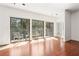 Bright living room with wood floors and glass doors leading to private balconies with outdoor seating at 3071 Lenox Ne Rd # 11, Atlanta, GA 30324