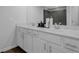 Modern bathroom features a double sink vanity with white cabinets and a sleek, tiled shower at 2136 Garden Pl, Atlanta, GA 30316