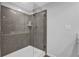Stylish bathroom featuring a walk-in shower with gray tile, a rainfall shower head, and glass enclosure at 2136 Garden Pl, Atlanta, GA 30316