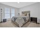 Bedroom with natural light features neutral decor, a queen bed, and a padded stool at 2136 Garden Pl, Atlanta, GA 30316