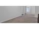 Light, airy bedroom with neutral carpet, base trim, and doorways to connecting rooms at 2136 Garden Pl, Atlanta, GA 30316