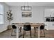 Dining area displays a wooden table with sleek black chairs and overhead lighting, next to the modern kitchen at 2136 Garden Pl, Atlanta, GA 30316