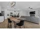 An open dining area featuring a dining table next to the living room and adjacent to the modern kitchen at 2136 Garden Pl, Atlanta, GA 30316