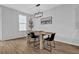 Bright dining area features a wood table, modern light fixture, and complements a minimalist interior at 2136 Garden Pl, Atlanta, GA 30316