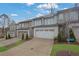 Street view of modern townhomes featuring neutral color palettes, two-car garages, and landscaping at 2136 Garden Pl, Atlanta, GA 30316