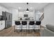 Contemporary kitchen features an island with barstool seating, stainless appliances and ample storage at 2136 Garden Pl, Atlanta, GA 30316