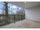 A covered patio offering an outdoor living space with wrought iron railing and wooded views at 2136 Garden Pl, Atlanta, GA 30316