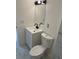 Updated powder room with a white vanity, black fixtures, modern lighting, and tile flooring at 4941 Isle Royal Ct, Stone Mountain, GA 30088