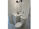 Updated powder room with a white vanity, black fixtures, modern lighting, and tile flooring at 4941 Isle Royal Ct, Stone Mountain, GA 30088
