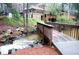 A quaint footbridge crossing over a small creek with a home in a wooded setting in the background at 4941 Isle Royal Ct, Stone Mountain, GA 30088