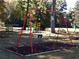 Red swing set and playground for residents to enjoy at 4941 Isle Royal Ct, Stone Mountain, GA 30088