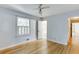 Cozy bedroom with hardwood floors, a window with white shutters, and a doorway to an en-suite bathroom at 130 Bonnie Ln, Sandy Springs, GA 30328