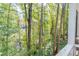 Deck with wooded view surrounded by large mature trees and greenery at 130 Bonnie Ln, Sandy Springs, GA 30328