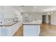 Open kitchen featuring a breakfast bar, hardwood floors, and plenty of natural light at 130 Bonnie Ln, Sandy Springs, GA 30328