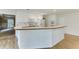 Functional kitchen featuring white cabinetry, bar seating, and seamless flow to other rooms at 130 Bonnie Ln, Sandy Springs, GA 30328