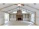 Cozy living room with a vaulted ceiling, fireplace, and built-in bookshelves at 130 Bonnie Ln, Sandy Springs, GA 30328