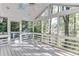 Sunroom featuring a white ceiling, skylight, ceiling fan, and several windows showcasing the wooded backyard at 130 Bonnie Ln, Sandy Springs, GA 30328