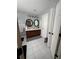 Bathroom featuring dual vanities, tile floor, and modern lighting at 2162 Fall Creek Ldg, Loganville, GA 30052