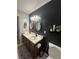 Charming bathroom with dual sinks, dark accent wall, and modern fixtures at 2162 Fall Creek Ldg, Loganville, GA 30052