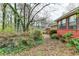 Side view of the house and backyard covered in foliage and leaves at 2516 Warwick Ne Cir, Atlanta, GA 30345