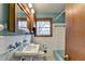 Bathroom featuring a white tile walls and blue fixtures and vanity cabinet at 2516 Warwick Ne Cir, Atlanta, GA 30345