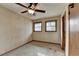 Bedroom with a ceiling fan, two windows, and wallpapered walls at 2516 Warwick Ne Cir, Atlanta, GA 30345