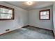 Light-filled bedroom with blue walls, carpeted flooring, and two windows at 2516 Warwick Ne Cir, Atlanta, GA 30345