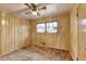 Comfortable bedroom with wood paneled walls, ceiling fan and carpeted floor at 2516 Warwick Ne Cir, Atlanta, GA 30345