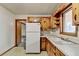 Traditional kitchen featuring a refrigerator, sink and knotty pine cabinetry at 2516 Warwick Ne Cir, Atlanta, GA 30345