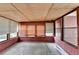 The sunroom features wood paneled walls, big windows, and a carpeted floor at 2516 Warwick Ne Cir, Atlanta, GA 30345