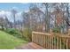 Wooden deck with railings overlooking a grassy backyard and trees at 3682 Harvest Dr, Decatur, GA 30034