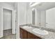 Bathroom featuring a granite countertop with double sinks, wood cabinetry, and an entry to walk-in closet at 3682 Harvest Dr, Decatur, GA 30034