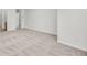 Bedroom featuring neutral carpet, white walls, with entryways to the bathroom and walk-in closet at 3682 Harvest Dr, Decatur, GA 30034