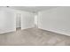 Bedroom featuring doorways to the bathroom and walk-in closet, neutral carpet, and white walls at 3682 Harvest Dr, Decatur, GA 30034
