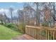 A spacious wooden deck overlooking the yard with mature trees, providing a serene and private outdoor space at 3682 Harvest Dr, Decatur, GA 30034