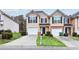 Inviting townhome features a well-manicured lawn, a one-car garage, and a charming front entrance at 3682 Harvest Dr, Decatur, GA 30034