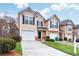 Well-maintained two-story townhome with a single-car garage and tidy front yard landscaping at 3682 Harvest Dr, Decatur, GA 30034